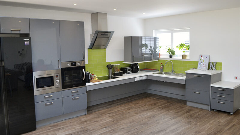 Nadir's fully accessible corner kitchen with ROPOX height-adjustable worktop and wheelchair space