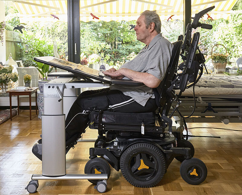 Jan using ROPOX Vision table from his wheelchair at home