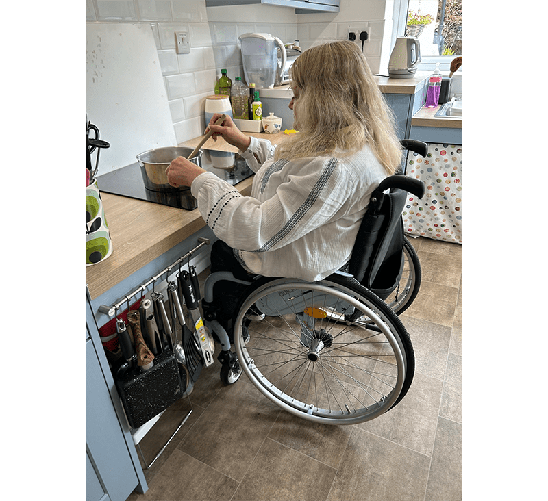 `Vanessa cooking independently using accessible kitchen worktop`