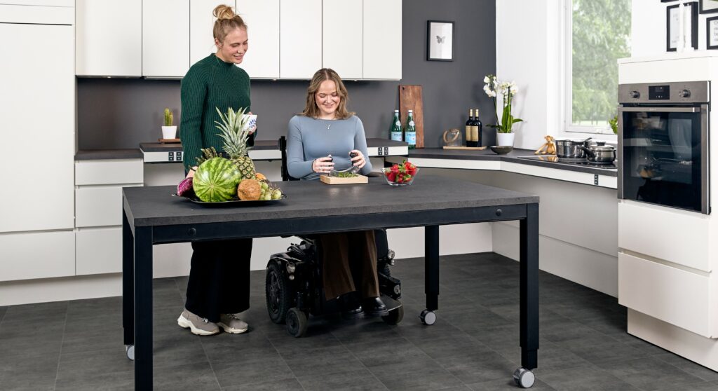 Ropox 4Single wheelchair accessible height adjustable table in modern kitchen environment