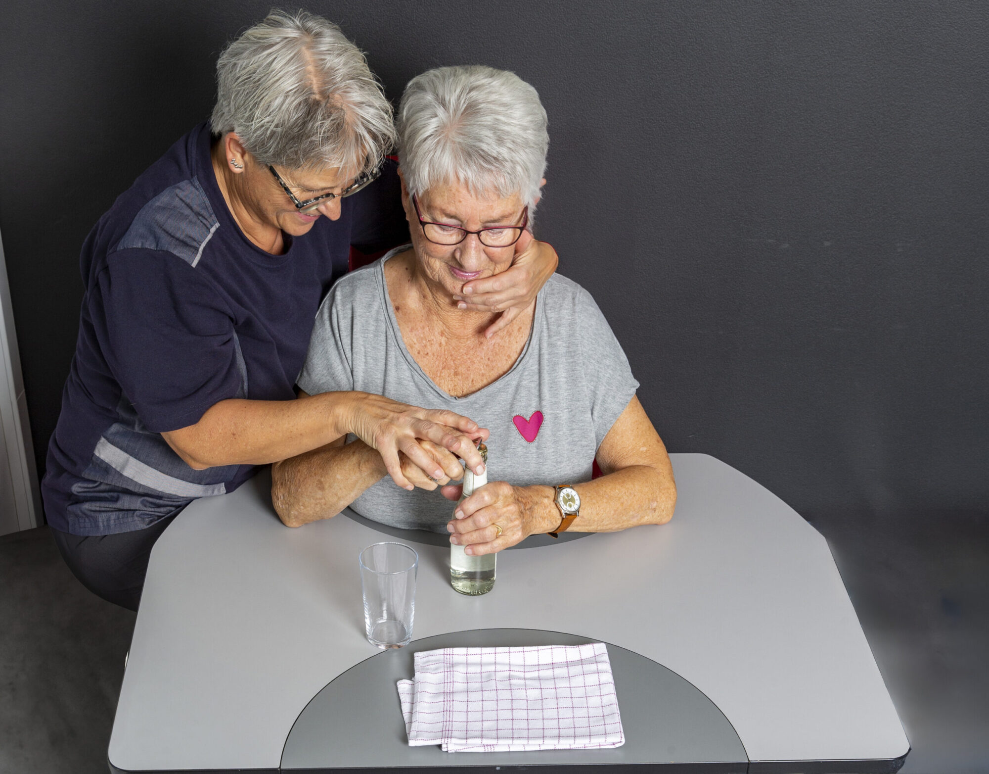 Therapist guiding an elderly patient at a Ropox ErgoMulti training table